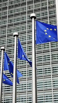 Flags Of The European Union Against The European Commission Building In Brussels Belgium Vertical Video