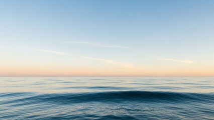 Obraz premium Calm Ocean Waves at Sunset with Clear Blue Sky and Soft Horizon Glow