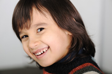 Cute smiling little boy with long hair