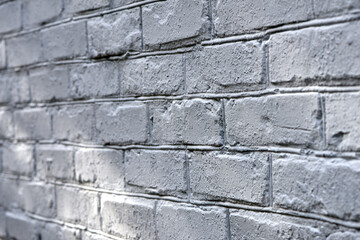 Fototapeta premium background, brick wall painted white. brick wall facade texture. old bricks in an exterior uneven wall of a house. masonry, construction, repair, restoration. space for text