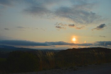 Fototapeta premium sunset behind the hill