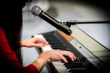 beautiful young woman playing the piano