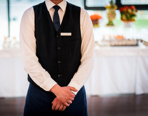 Young waiter at the restaurant