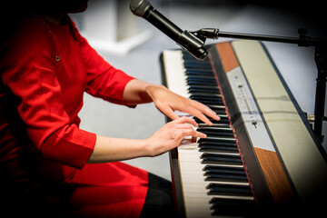 beautiful young woman playing the piano