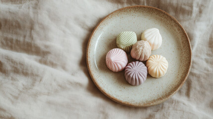 Matte Pastel Christmas Sweets on Ceramic Plate, Minimal Composition, Neutral Background, Holiday Dessert Flat Lay, Elegant Festive Treats
