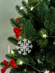 Christmas tree decorated with bows, star garland and white snowflake toy