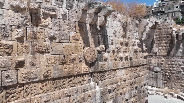 Close up view of Arabic inscriptions and stone carvings on historic Urfa Gate wall