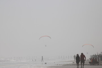 Paragliders in the Beach Sky
