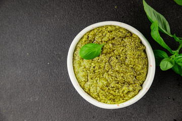 Pesto sauce basil, olive oil, parmesan, pine nuts, garlic natural product tasty snack fresh delicious gourmet food background on the table rustic top view copy space