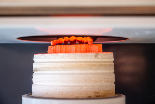 Zirconia dental crown firing process in sintering furnace under high temperature, ceramic prosthetics production in modern dental lab.