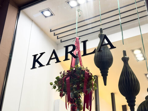 Zagreb, Croatia - December 14, 2025: Storefront of Karla featuring elegant decorations with hanging ornaments and a festive floral arrangement, showcasing a vibrant shopping atmosphere