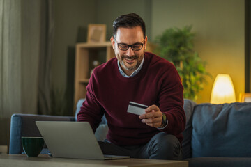 Man shopping online using laptop and credit card