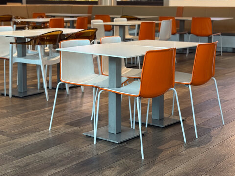 Food court with orange chairs. Modern dining, social life, and public interior.