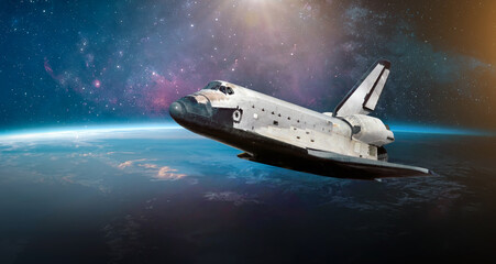 Space shuttle launch in outer space from Earth planet. Orbit and horizon of Earth. Sunlight and stars in deep space. Expedition to Universe. Elements of this image furnished by NASA. Not AI content