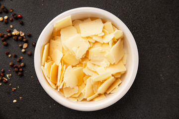 Parmesan cheese slices natural healthy food ingredient appetizer fresh tasty table setting gourmet food background on the table rustic food top view copy space