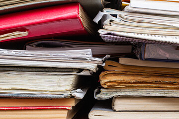 image of a stack of paperback books on the end of the pages toned with a retro vintage warm instagram like filter app or action effect