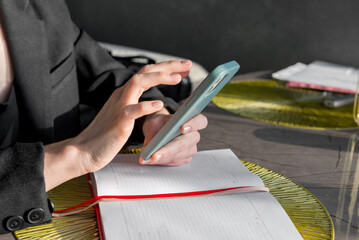 Close-up of a hand holding a phone and typing a message, close-up.