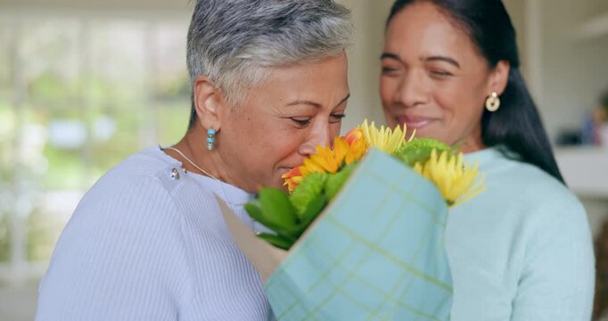Happy, mothers day and woman with flowers for surprise, gift and love for family, support and care in home. Wow, thank you and mom with floral, present and person giving parent a bouquet in house