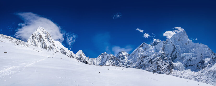 Mt. Kala Patthar slope with the trekking route and benches. Pumo Ri, Lingtren, Khumbutse, Lhotse, Everest and Nuptse mountains on the horizon. The highest point of Everest base camp trekking in Nepal.