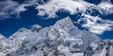 Panoramic view of the highest mountains in the world, Mahalangur Himal from Kala Patthar slope. Cirrus clouds over high snowy mountain ridge with Mt. Everest.