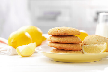 Tasty lemon cookies and fruits on white wooden table, closeup