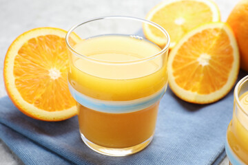 Fresh orange juice and fruits on table, closeup