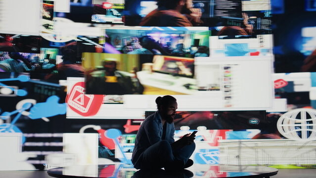 Caught in the toxic cycle of social media, disturbed man shows signs of social anxiety and obsessive behavior driven by excessive information online content, harmful smartphone dependence. Camera B.