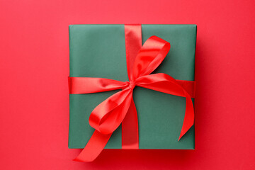 Beautiful gift box on red background, top view