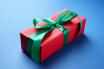 Beautiful gift box on blue background, closeup