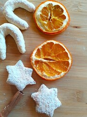 Fresh homemade holiday cookies with sugar powder, dry oranges and spices, Christmas cookie background