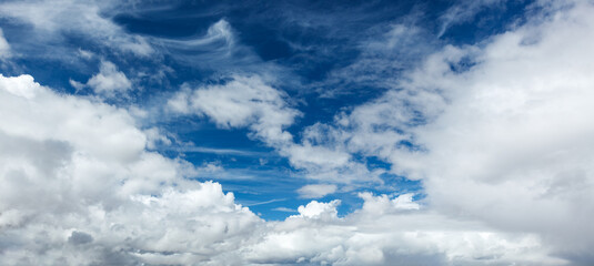 Serene sky with fluffy clouds on a bright blue day
