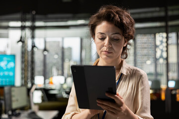 Fototapeta premium Motivated professional reviews business charts and graphs to create reports, demonstrating effective management and strategic planning skills aimed at driving success and results.