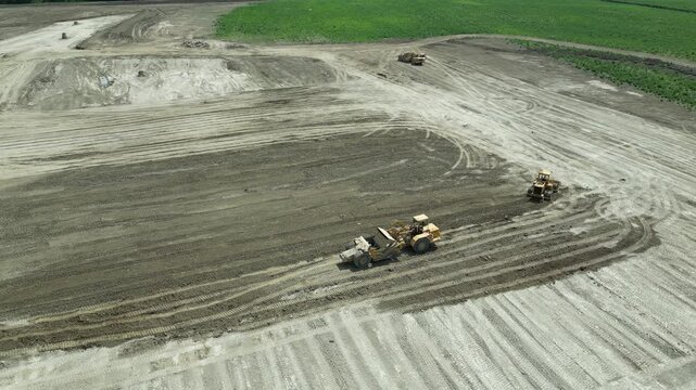 Vertical aerial view of earthmoving and civil engineering machinery in operation - Vue a&eacute;rienne verticale d'engin de terrassement et travaux publics en activit&eacute;
