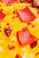 Close-up of a slice of pizza with artisanal ham, fresh pineapple, and melted cheese.