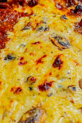 Close-up of a slice of chicken pizza with mushrooms