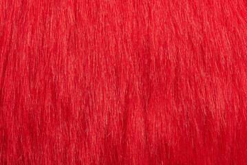 Artificial red fur coat macro photo as a background.