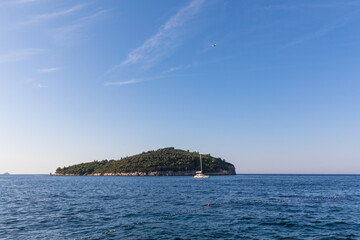 The Adriatic Sea on a quiet, peaceful, sunny summer day. A ship and an island in the distance. Croatia