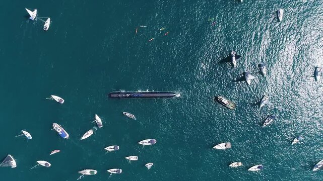 Israeli Navy Submarine Surrounded by Boats

Aerial view of an Israeli Navy Dolphin class submarine on the sea surface, surrounded by civilian sailboats during a maritime event, Israel, November 2025.
