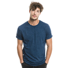 Casual Confidence: A stylish man with wavy hair, sports a classic blue t-shirt and embodies effortless cool. His poise and casual demeanor exude confidence and approachability.