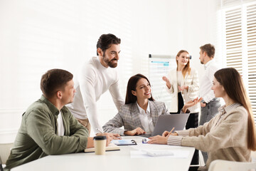 Business planning. Colleagues having meeting in office, selective focus