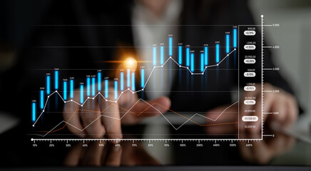 A business professional engages with financial data, using hand gestures to analyze a rising graph...