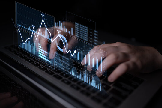 A captivating image of hands typing on a laptop, surrounded by holographic graphs and charts that represent financial data analysis and modern business trends. Scalp - Powered by Adobe