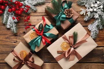 Fototapeta premium Gift boxes and Christmas decor on wooden table, flat lay