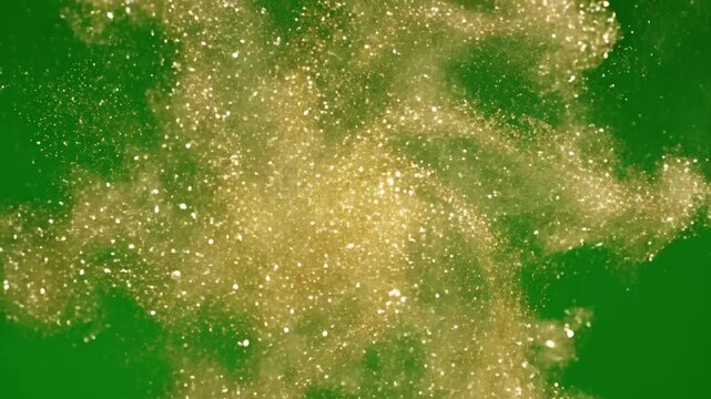 Swirling gold dust particles suspended in air with abstract gold dust patterns creating effect green screen gold dust shimmer style