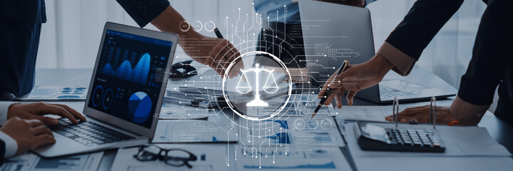 A business team collaborates in a modern office, focusing on legal and financial strategies while utilizing technology and data analysis for informed decision-making. Trope
