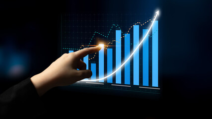 A hand interacts with a digital screen displaying an upward graph, symbolizing financial growth, data analysis, and modern technology in business settings. Impute