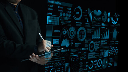 A professional analyzing business data through advanced visual analytics on a touchscreen display. The image represents decision-making strategies in a modern office environment. Cipher