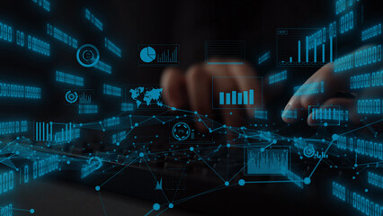 A close-up view of hands typing on a keyboard surrounded by futuristic data analytics visuals, illustrating technology trends with graphs, charts, and digital information. Xenic