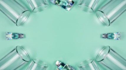 Glass cylinders and crystals on pastel green background with copy space for product display