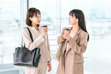 Businesswoman coming to the office with coffee